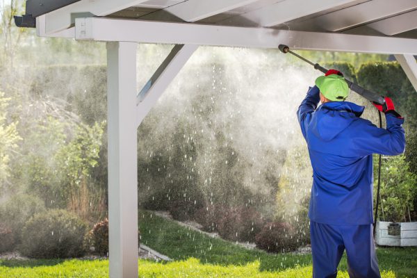 Porch Roof Power Cleaning. Caucasian Men with Pressure Washer.